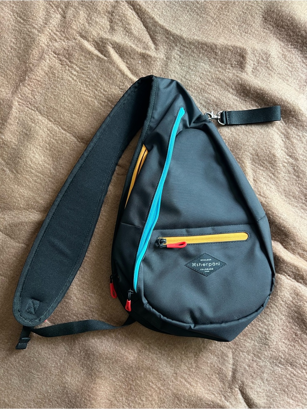 Sherpani Black Sling Bag with Teal and Yellow Accents NWOT